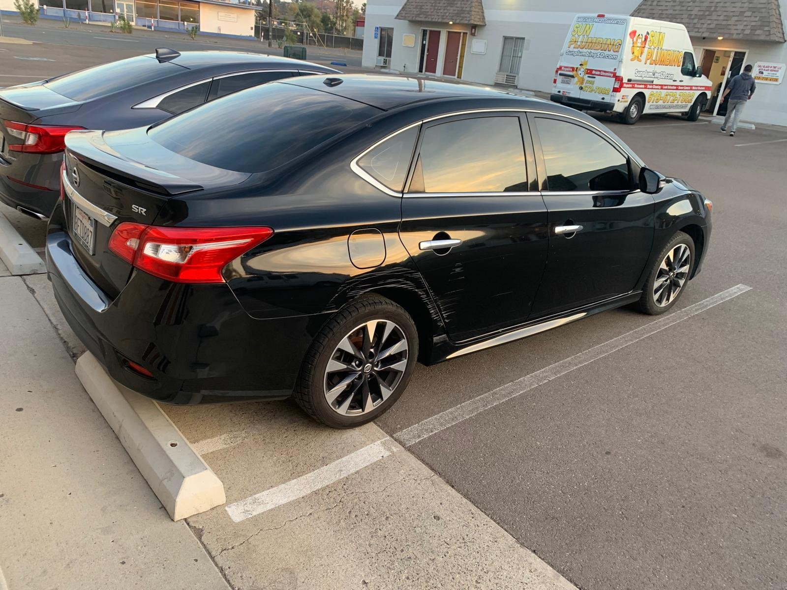 a black car with window tinted in the shop located in El Cajon - Cali Auto glass & tint