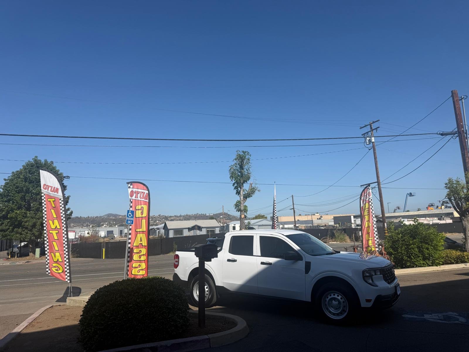 Tinted Ford Maverick truck parked outside Cali Auto Glass and Tint shop in El Cajon California