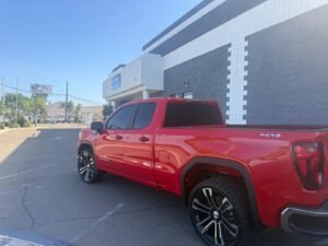 Red GMC Sierra 1500 4x4 pickup truck after ceramic window tint installation in El Cajon