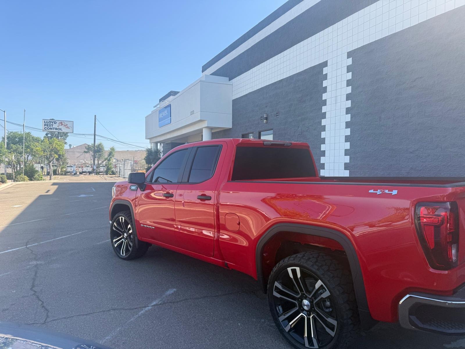 Red GMC Sierra 1500 4x4 pickup truck after ceramic window tint installation in El Cajon