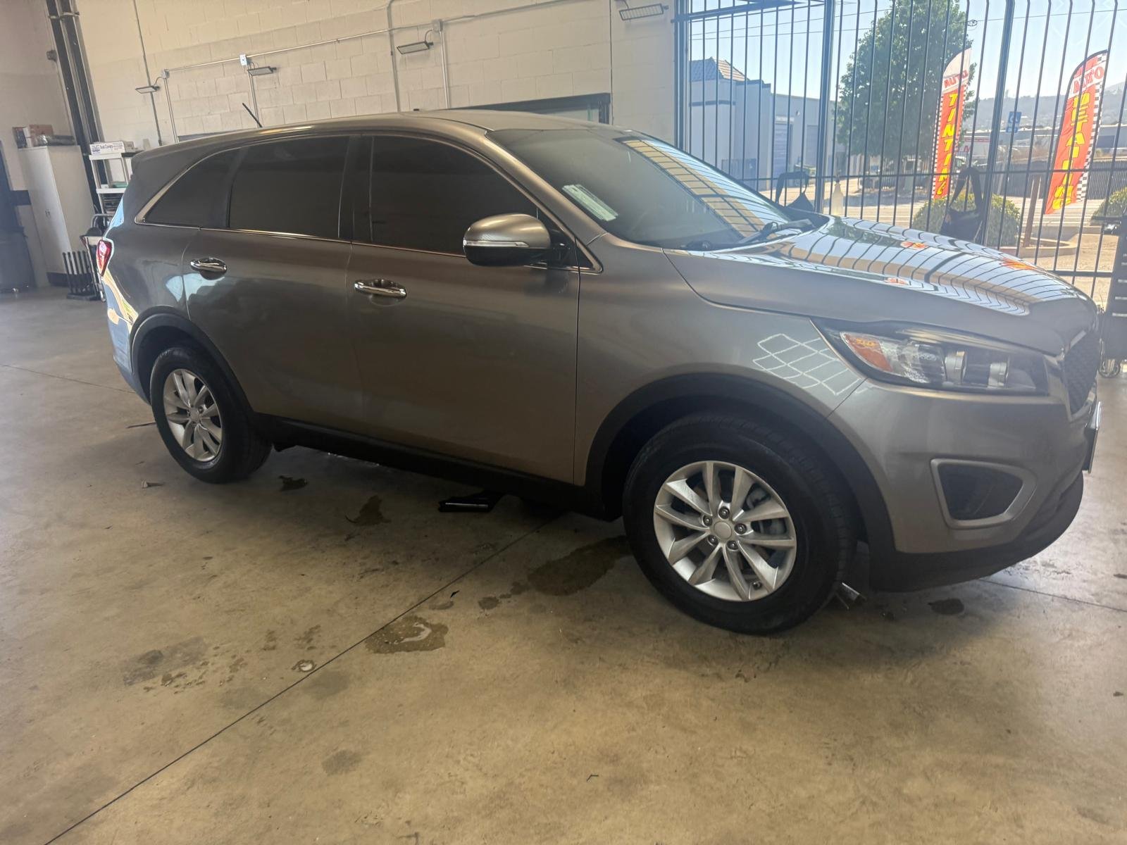 Gray Kia Sorento SUV parked inside the El Cajon window tint shop